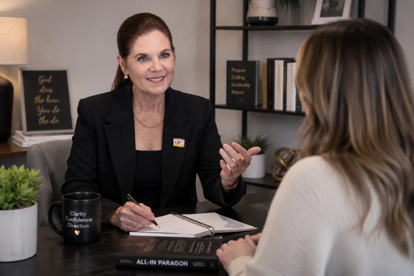Carole Mendoza coaching a client at her desk in Pooler, Georgia