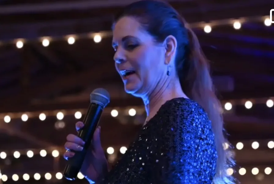 Carole Mendoza speaking with a microphone